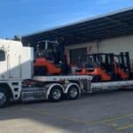 Tow truck towing forklifts