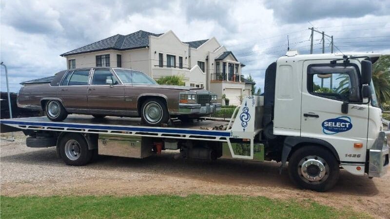 A classic car being towed