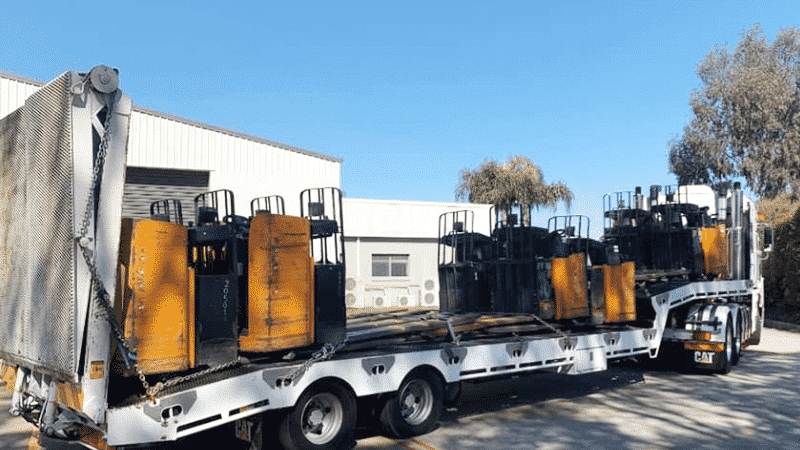 Pallet forklifts being transported