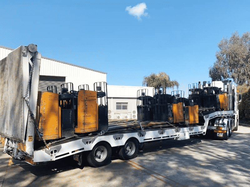 A truck loaded with pallet forklifts proving the service, machinery transport