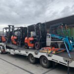 Four Toyota Forklifts being transported