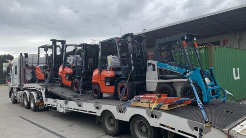 Four Toyota Forklifts being transported