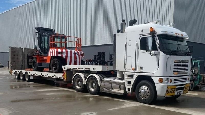 A prime mover loaded with Toyota forklifts representing the forklift transport available for Sydney and interstate customers