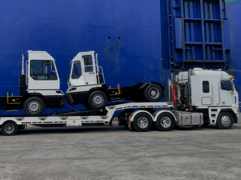 Truck towing two heavy vehicles