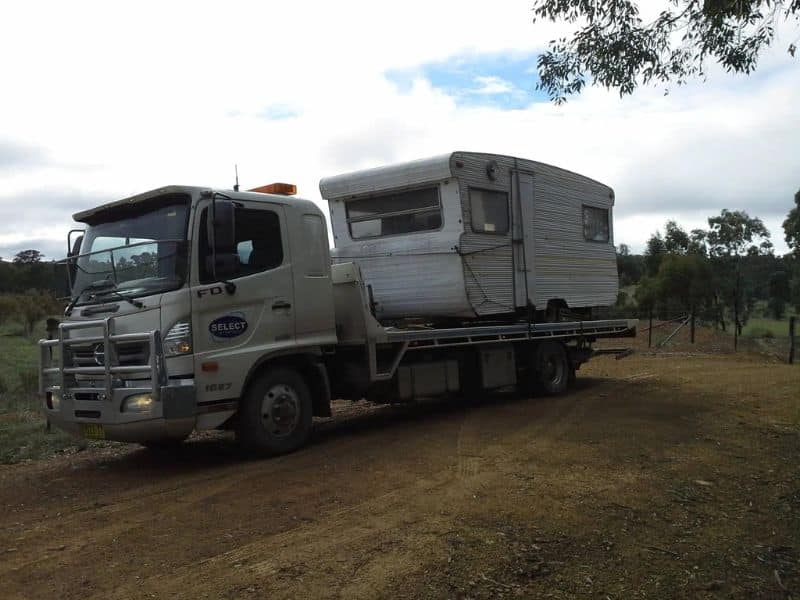 Caravan being towed interstate on tow truck