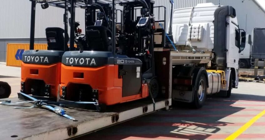 Toyota forklifts being transported on a low bed tow truck