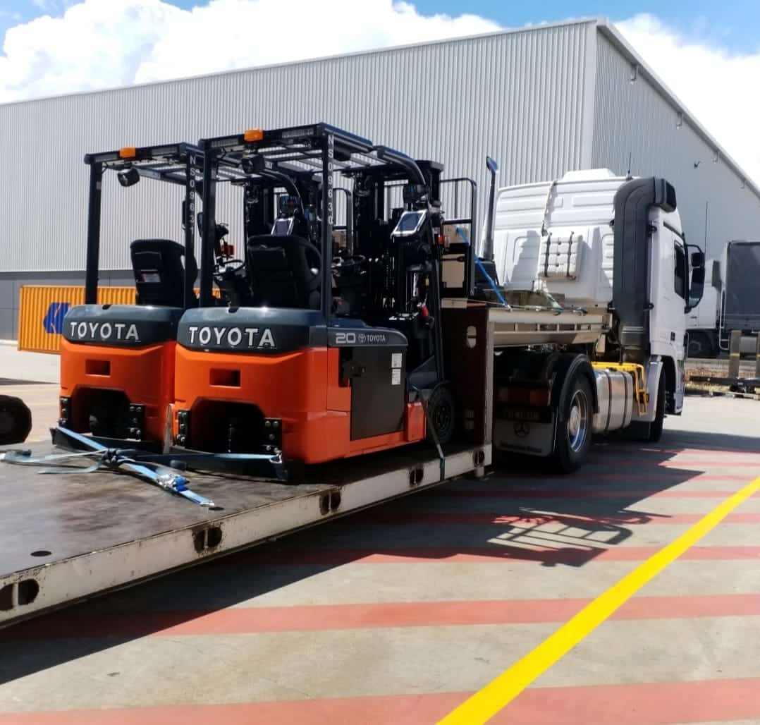 Toyota forklifts being transported on a low bed tow truck