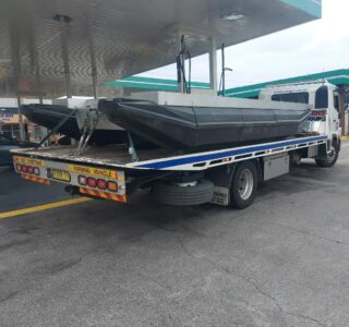Barge boat being transport from Central Coast on a flat bed tow truck
