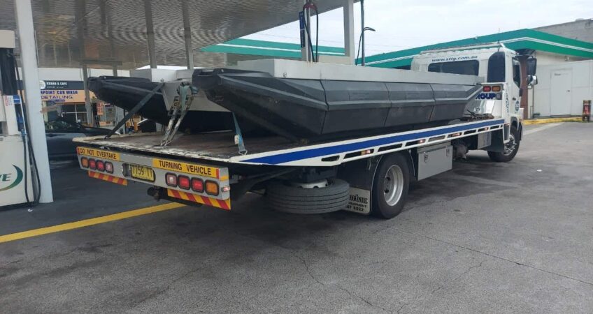 Barge boat being transport from Central Coast on a flat bed tow truck