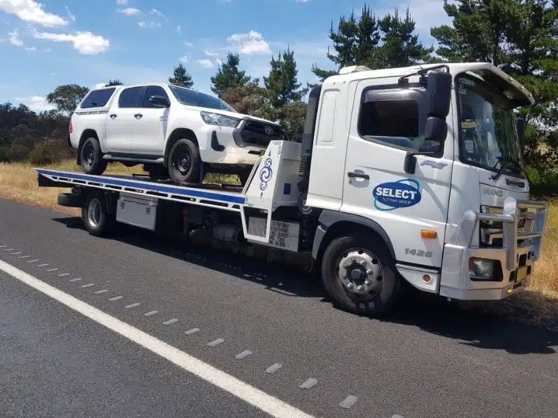 Car loaded onto a tow truck for safe transport.