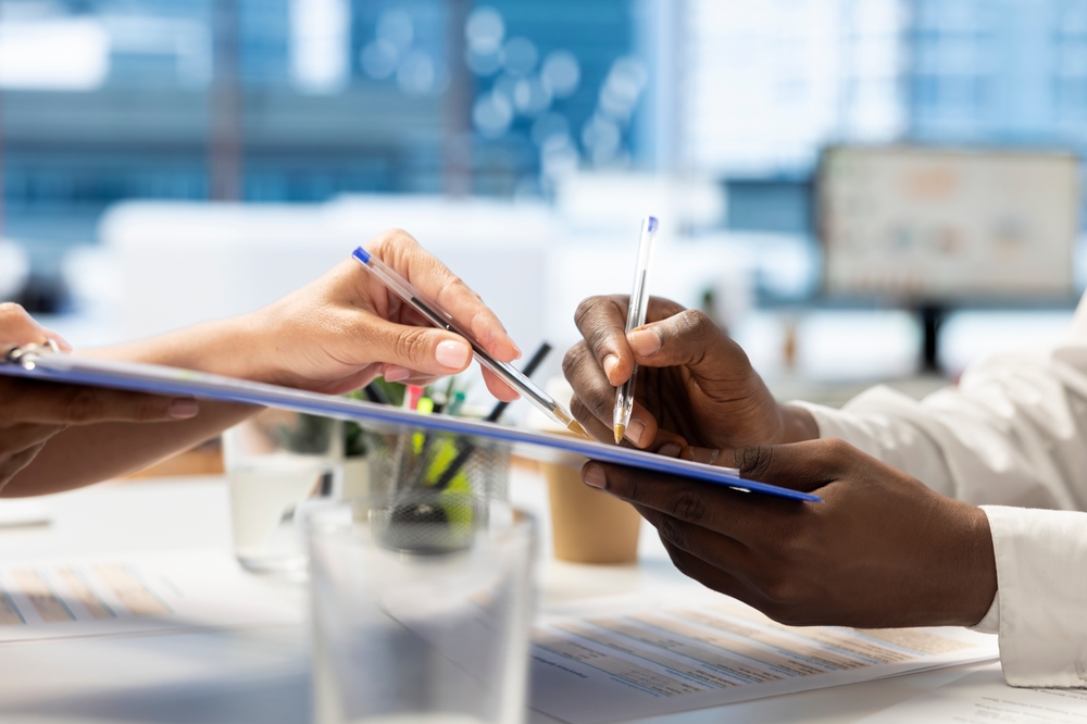 People signing transport paperwork.